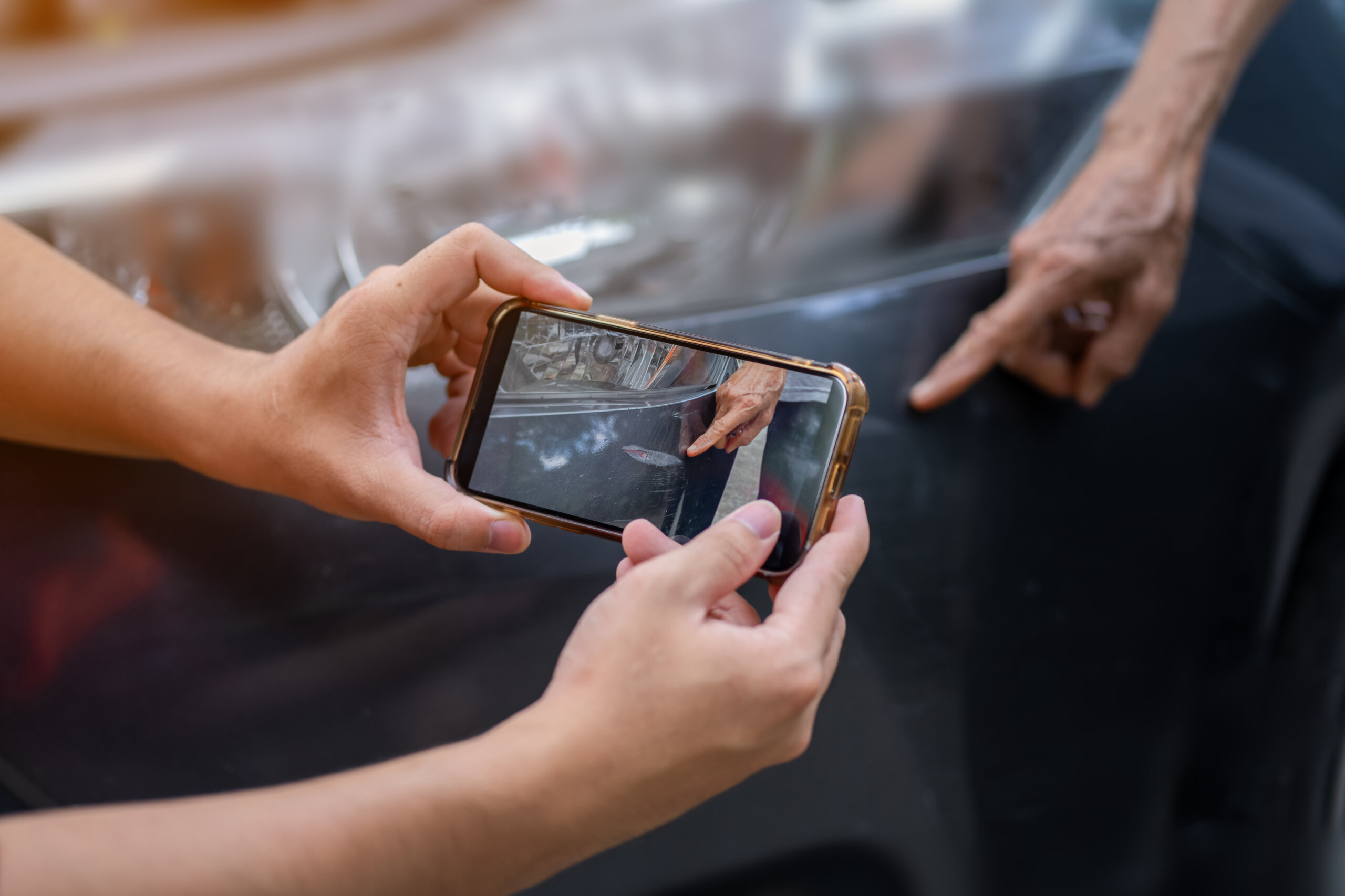 man taking picture of car accident