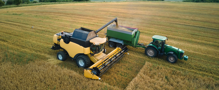 Farm machinery going over a grain field