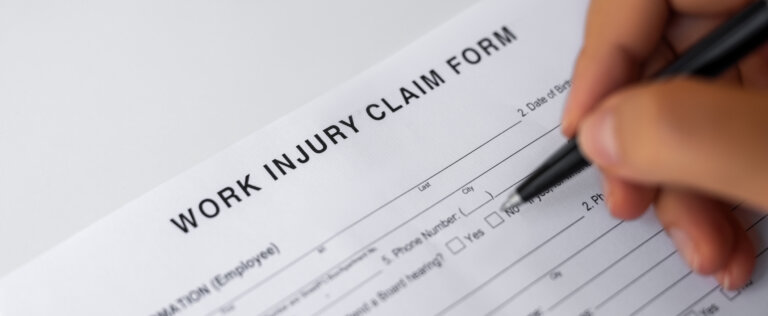 Woman filling Work Injury Claim Form