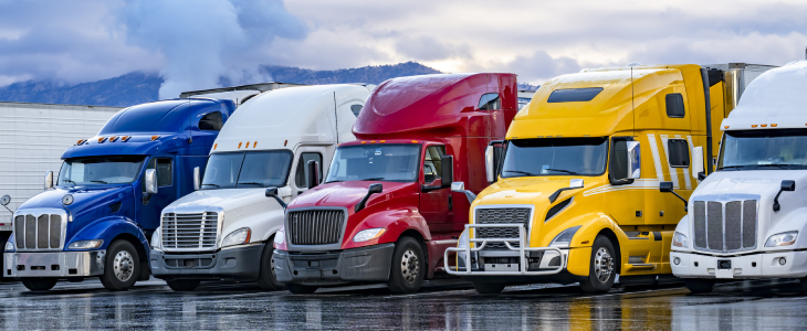 Trucks sitting on the side of a parking lot