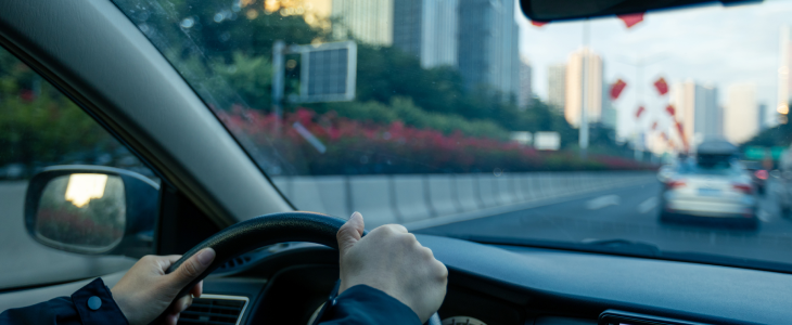 Rideshare driver on a highway in a car