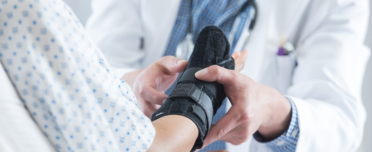 Doctor helping patient with a broken bone injury