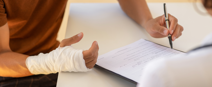 Man with a broken bone injury reaching out to a personal injury attorney in North Dakota