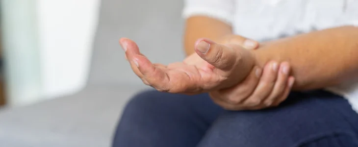 Women holding her wrist due to a repetitive motion injury.